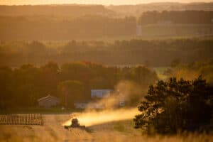 Dust kicking up from a farmers combine in a Wisconsin soybean field, horizontal